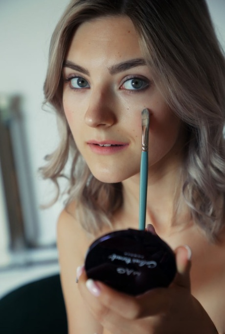 Молодая платиновая блондинка Ева Элфи делает макияж во время выступления обнаженной модели 2